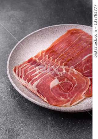Meat, ham, jamon, or prosciutto sliced for breakfast bruschetta. Sliced ham, jamon, or prosciutto 135763777
