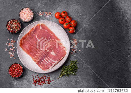 Meat, ham, jamon, or prosciutto sliced for breakfast bruschetta. Sliced ham, jamon, or prosciutto 135763783