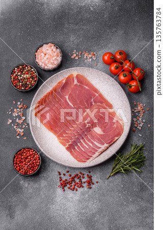 Meat, ham, jamon, or prosciutto sliced for breakfast bruschetta. Sliced ham, jamon, or prosciutto 135763784