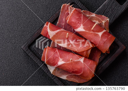 Meat, ham, jamon, or prosciutto sliced for breakfast bruschetta. Sliced ham, jamon, or prosciutto 135763790