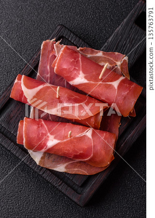Meat, ham, jamon, or prosciutto sliced for breakfast bruschetta. Sliced ham, jamon, or prosciutto Meat, ham, jamon, or prosciutto sliced for breakfast bruschetta. Sliced ham, jamon, or prosciutto 135763791