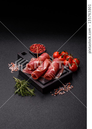 Meat, ham, jamon, or prosciutto sliced for breakfast bruschetta. Sliced ham, jamon, or prosciutto 135763801