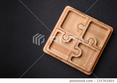 Wooden empty puzzle serving tray, kitchen accessories. A wooden empty puzzle tray Wooden empty puzzle serving tray, kitchen accessories. A wooden empty puzzle tray 135763803