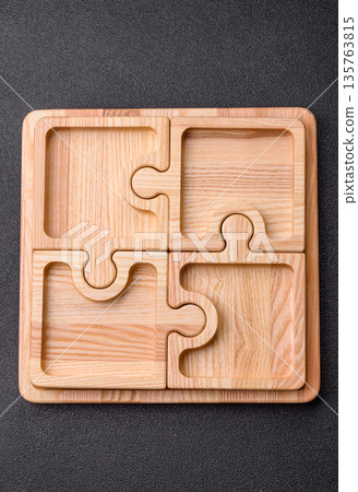 Wooden empty puzzle serving tray, kitchen accessories. A wooden empty puzzle tray 135763815