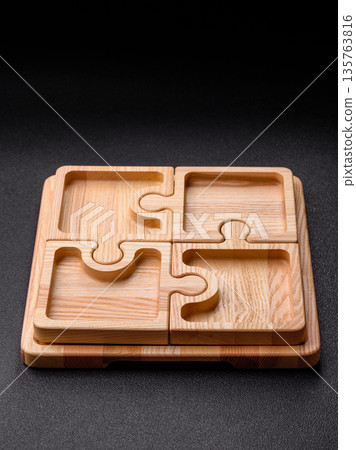 Wooden empty puzzle serving tray, kitchen accessories. A wooden empty puzzle tray 135763816