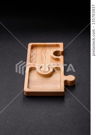 Wooden empty puzzle serving tray, kitchen accessories. A wooden empty puzzle tray Wooden empty puzzle serving tray, kitchen accessories. A wooden empty puzzle tray 135763837