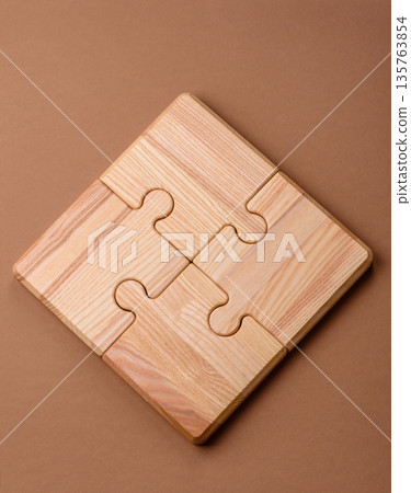 A wooden empty puzzle piece for a sign or business concept. A wooden empty puzzle A wooden empty puzzle piece for a sign or business concept. A wooden empty puzzle 135763854