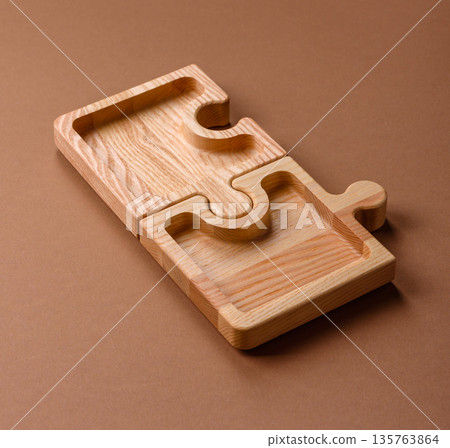 Wooden empty puzzle serving tray, kitchen accessories. A wooden empty puzzle tray 135763864