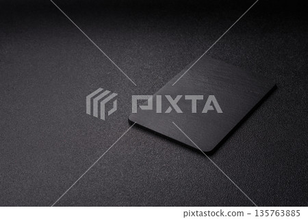A black slate stone board or plate, an empty kitchen utensil. A black slate board A black slate stone board or plate, an empty kitchen utensil. A black slate board 135763885