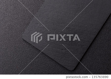 A black slate stone board or plate, an empty kitchen utensil. A black slate board 135763890