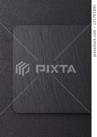 A black slate stone board or plate, an empty kitchen utensil. A black slate board 135763895