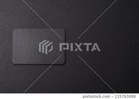 A black slate stone board or plate, an empty kitchen utensil. A black slate board 135763898