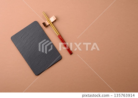 A black slate stone board or plate, an empty kitchen utensil. A black slate board 135763914