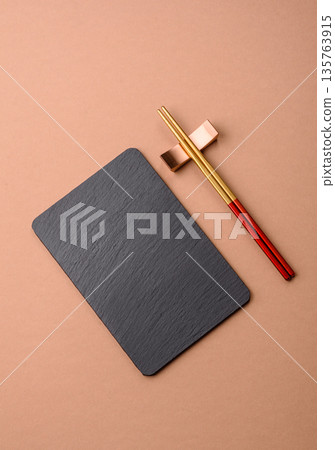 A black slate stone board or plate, an empty kitchen utensil. A black slate board A black slate stone board or plate, an empty kitchen utensil. A black slate board 135763915