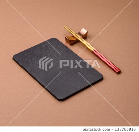 A black slate stone board or plate, an empty kitchen utensil. A black slate board A black slate stone board or plate, an empty kitchen utensil. A black slate board 135763916