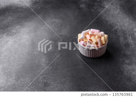 Mini marshmallows in white, pink, and pastel colors. Marshmallows as a food background Mini marshmallows in white, pink, and pastel colors. Marshmallows as a food background 135763981