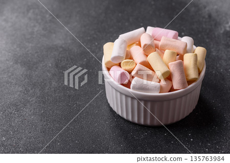 Mini marshmallows in white, pink, and pastel colors. Marshmallows as a food background Mini marshmallows in white, pink, and pastel colors. Marshmallows as a food background 135763984