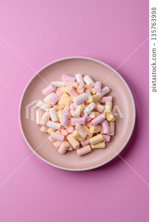 Mini marshmallows in white, pink, and pastel colors. Marshmallows as a food background Mini marshmallows in white, pink, and pastel colors. Marshmallows as a food background 135763998