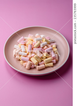 Mini marshmallows in white, pink, and pastel colors. Marshmallows as a food background Mini marshmallows in white, pink, and pastel colors. Marshmallows as a food background 135763999