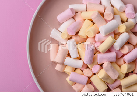 Mini marshmallows in white, pink, and pastel colors. Marshmallows as a food background Mini marshmallows in white, pink, and pastel colors. Marshmallows as a food background 135764001