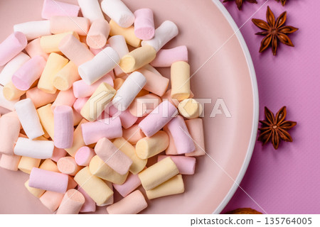 Mini marshmallows in white, pink, and pastel colors. Marshmallows as a food background Mini marshmallows in white, pink, and pastel colors. Marshmallows as a food background 135764005