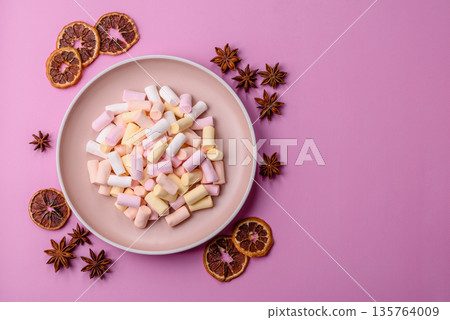 Mini marshmallows in white, pink, and pastel colors. Marshmallows as a food background 135764009