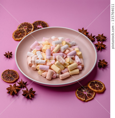 Mini marshmallows in white, pink, and pastel colors. Marshmallows as a food background Mini marshmallows in white, pink, and pastel colors. Marshmallows as a food background 135764011