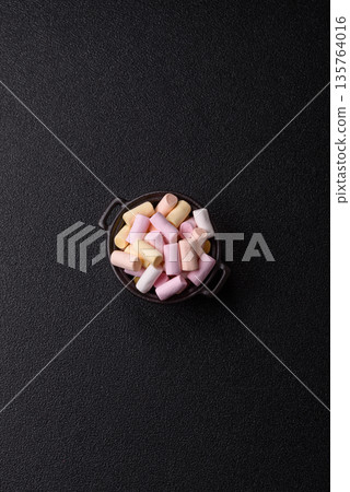 Mini marshmallows in white, pink, and pastel colors. Marshmallows as a food background 135764016