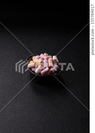 Mini marshmallows in white, pink, and pastel colors. Marshmallows as a food background Mini marshmallows in white, pink, and pastel colors. Marshmallows as a food background 135764017