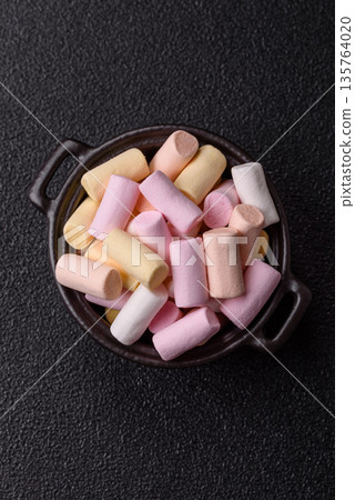 Mini marshmallows in white, pink, and pastel colors. Marshmallows as a food background Mini marshmallows in white, pink, and pastel colors. Marshmallows as a food background 135764020