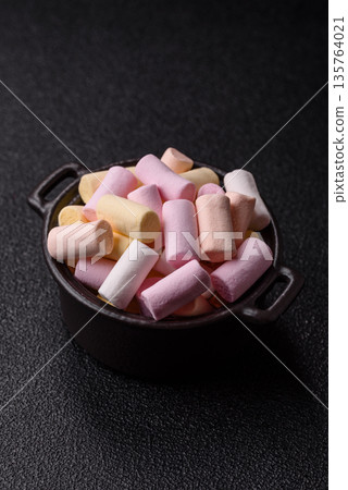 Mini marshmallows in white, pink, and pastel colors. Marshmallows as a food background Mini marshmallows in white, pink, and pastel colors. Marshmallows as a food background 135764021