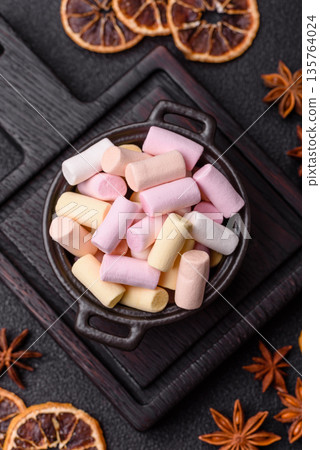 Mini marshmallows in white, pink, and pastel colors. Marshmallows as a food background 135764024
