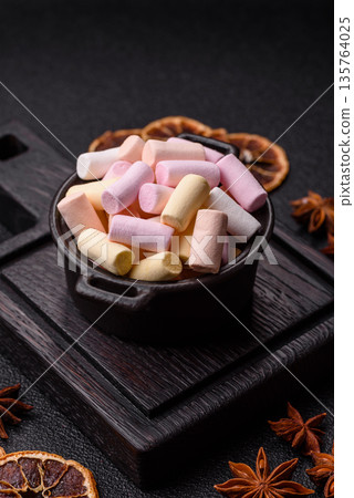 Mini marshmallows in white, pink, and pastel colors. Marshmallows as a food background Mini marshmallows in white, pink, and pastel colors. Marshmallows as a food background 135764025