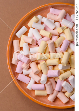 Mini marshmallows in white, pink, and pastel colors. Marshmallows as a food background 135764036