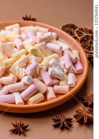 Mini marshmallows in white, pink, and pastel colors. Marshmallows as a food background Mini marshmallows in white, pink, and pastel colors. Marshmallows as a food background 135764041