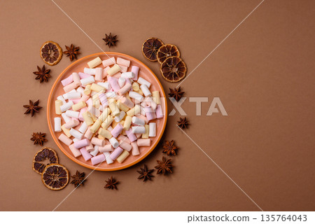 Mini marshmallows in white, pink, and pastel colors. Marshmallows as a food background Mini marshmallows in white, pink, and pastel colors. Marshmallows as a food background 135764043