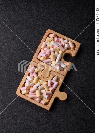 Mini marshmallows in white, pink, and pastel colors. Marshmallows as a food background Mini marshmallows in white, pink, and pastel colors. Marshmallows as a food background 135764063