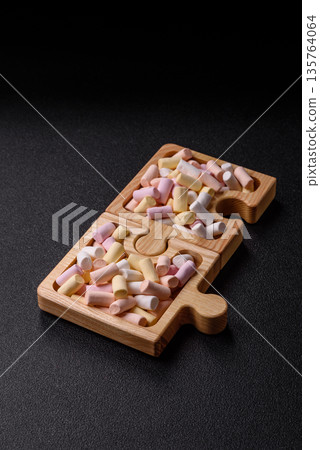 Mini marshmallows in white, pink, and pastel colors. Marshmallows as a food background Mini marshmallows in white, pink, and pastel colors. Marshmallows as a food background 135764064