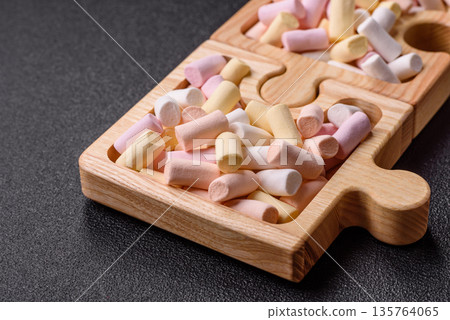 Mini marshmallows in white, pink, and pastel colors. Marshmallows as a food background Mini marshmallows in white, pink, and pastel colors. Marshmallows as a food background 135764065