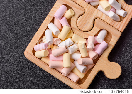 Mini marshmallows in white, pink, and pastel colors. Marshmallows as a food background Mini marshmallows in white, pink, and pastel colors. Marshmallows as a food background 135764066