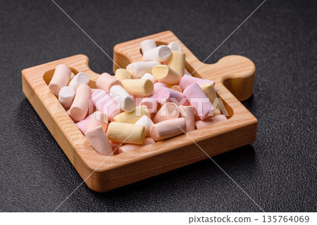 Mini marshmallows in white, pink, and pastel colors. Marshmallows as a food background 135764069