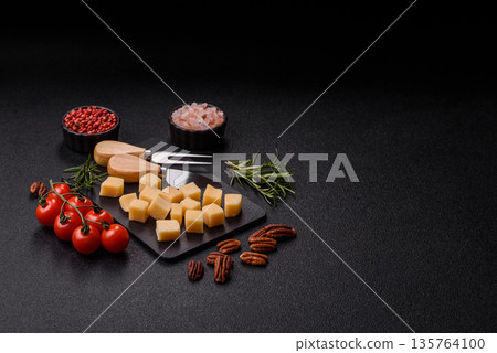 Cubed cheddar, gouda, or parmesan cheese on a cutting board. Cubed cheese Cubed cheddar, gouda, or parmesan cheese on a cutting board. Cubed cheese 135764100