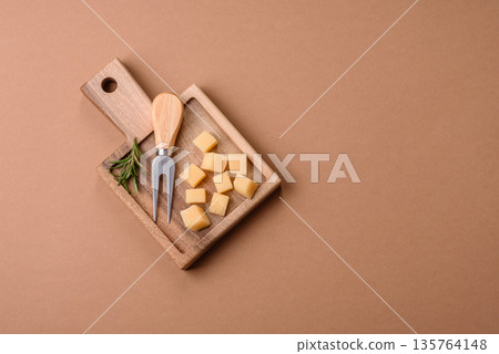 Cubed cheddar, gouda, or parmesan cheese on a cutting board. Cubed cheese Cubed cheddar, gouda, or parmesan cheese on a cutting board. Cubed cheese 135764148