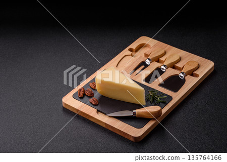 A wedge of cheddar, gouda, or parmesan cheese on a cutting board. Cheese wedge A wedge of cheddar, gouda, or parmesan cheese on a cutting board. Cheese wedge 135764166
