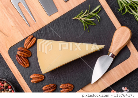 A wedge of cheddar, gouda, or parmesan cheese on a cutting board. Cheese wedge A wedge of cheddar, gouda, or parmesan cheese on a cutting board. Cheese wedge 135764173