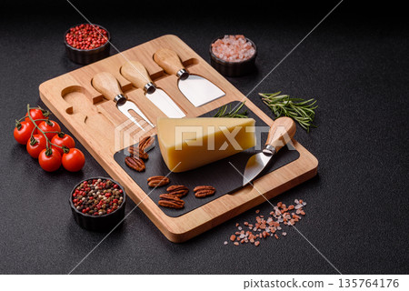 A wedge of cheddar, gouda, or parmesan cheese on a cutting board. Cheese wedge A wedge of cheddar, gouda, or parmesan cheese on a cutting board. Cheese wedge 135764176