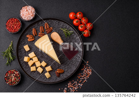 A wedge of cheddar, gouda, or parmesan cheese on a cutting board. Cheese wedge A wedge of cheddar, gouda, or parmesan cheese on a cutting board. Cheese wedge 135764242