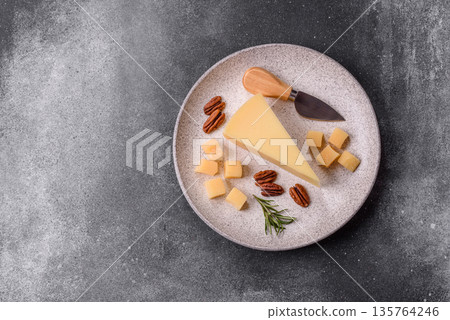 A wedge of cheddar, gouda, or parmesan cheese on a cutting board. Cheese wedge A wedge of cheddar, gouda, or parmesan cheese on a cutting board. Cheese wedge 135764246