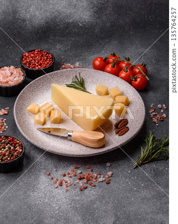 A wedge of cheddar, gouda, or parmesan cheese on a cutting board. Cheese wedge A wedge of cheddar, gouda, or parmesan cheese on a cutting board. Cheese wedge 135764257