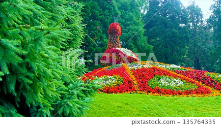 Vibrant Garden Woman, Bright And Lively Sculpture Of Woman With Blooming Flowers In Peaceful Park Setting Vibrant Garden Woman, Bright And Lively Sculpture Of Woman With Blooming Flowers In Peaceful Park Setting 135764335